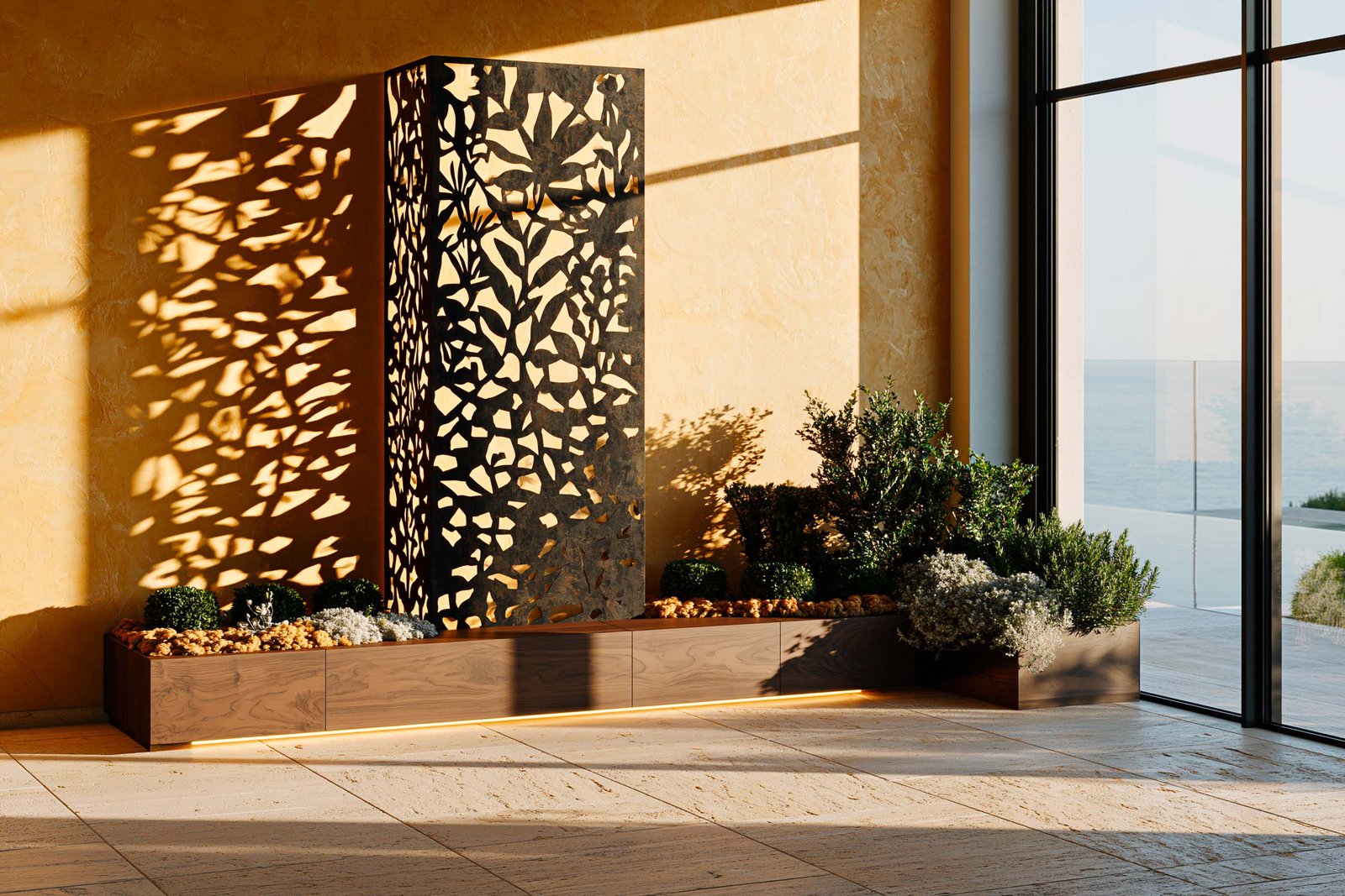 Jardin intérieur — atrium d’une villa contemporaine au Cap-Ferrat au golden hour, partition Hortus Velum™ Arcana en Acciaio Brunito à motif végétal ajouré dressée en dispositif central freestanding double-hauteur de l’atrium, rétro-éclairée par le soleil de fin de journée traversant ses découpes et projetant des ombres botaniques élaborées sur le sol travertin clair et le mur stucco lustro ocre patiné, planter Lignum™ Block en noyer fumé au pied portant Buxus sempervirens en topiaires boules de tailles égales rythmées, Helichrysum italicum en touffes argentées et Rosmarinus officinalis en accent latéral, baie vitrée latérale ouvrant sur l’horizon Méditerranée, LED 2700K cachée, Paracelsus Gardens™